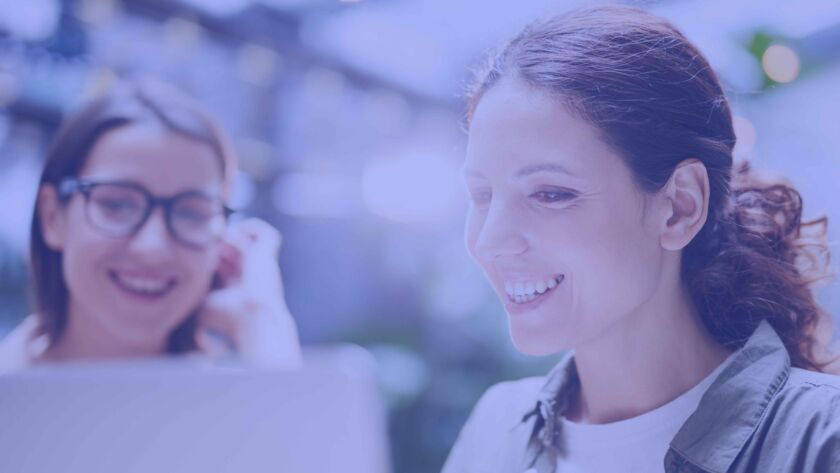 Two lady programmers working on a landing page